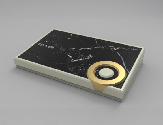 sleek USB audio device with a black marble top and a gold circular control knob, viewed from an angle.
